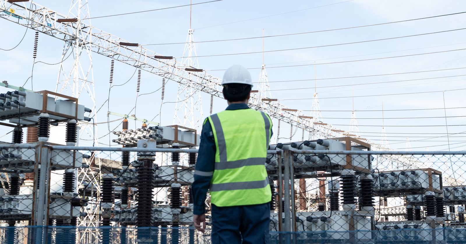 A technician inspecting and testing an installed down-conductor and earth connection during a scheduled maintenance visit