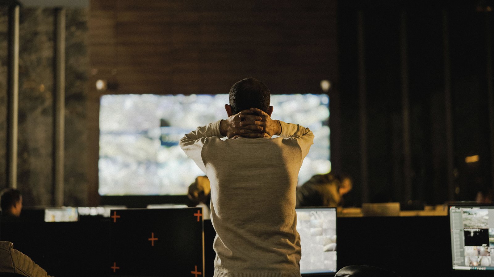 An operations team responding to a thunderstorm warning in a control room.